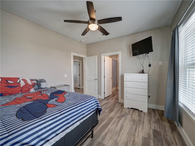 bedroom with hardwood / wood-style floors and ceiling fan