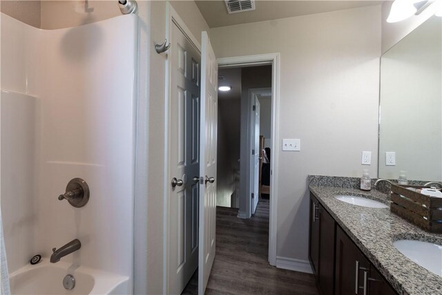 11766 Fm 70, Robstown, TX 78380 - bathroom featuring double vanity, wood finished floors, and bathtub / shower combination