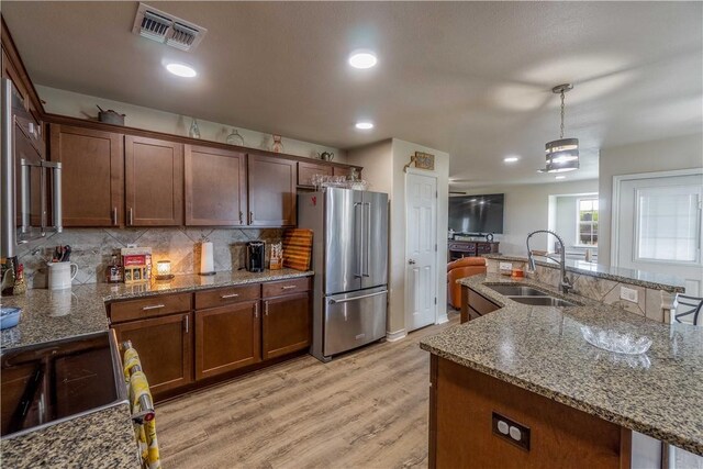 11766 Fm 70, Robstown, TX 78380 - kitchen with stainless steel appliances, light wood-type flooring, pendant lighting, recessed lighting, and tasteful backsplash