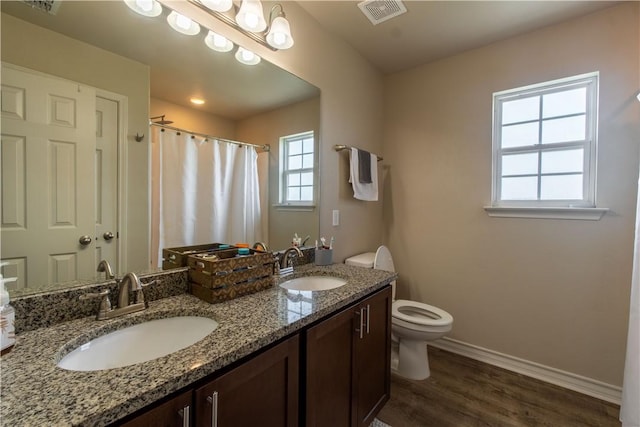 11766 Fm 70, Robstown, TX 78380 - full bath featuring double vanity, wood finished floors, and a shower with shower curtain