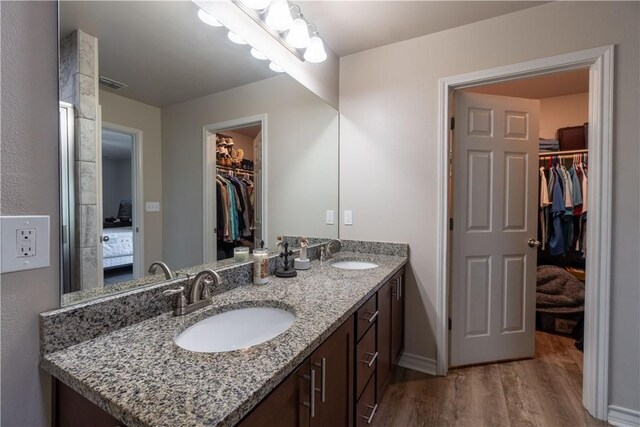 11766 Fm 70, Robstown, TX 78380 - full bath with a spacious closet, double vanity, wood finished floors, and ensuite bathroom