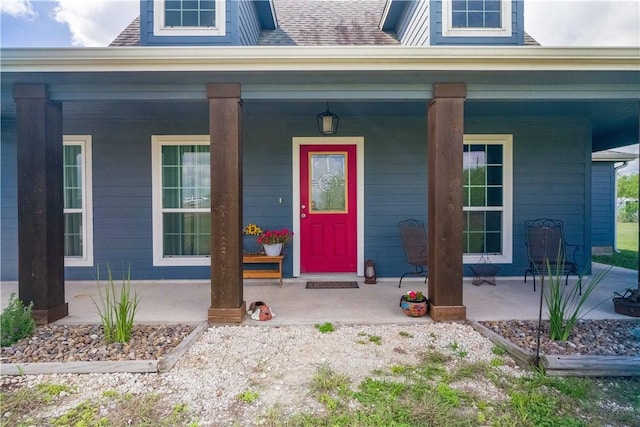 11766 Fm 70, Robstown, TX 78380 - cape cod home featuring a porch, a front yard, and a shingled roof