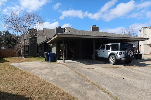 view of side of property with a yard and a carport