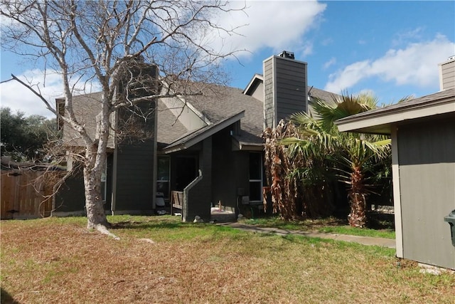 view of side of property with a lawn