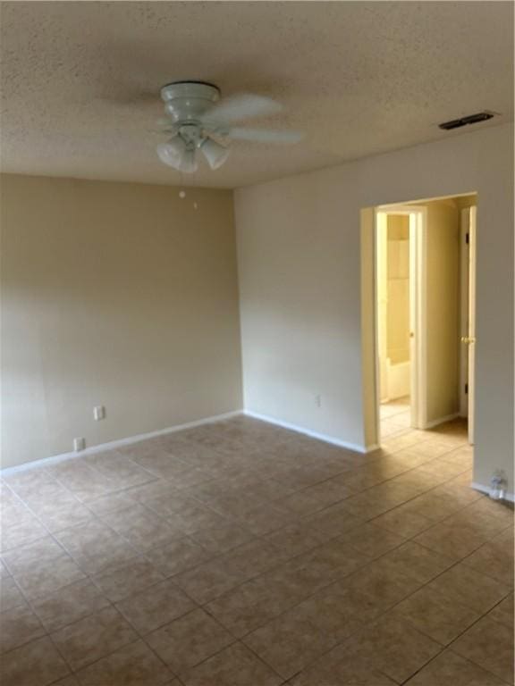 spare room featuring ceiling fan and a textured ceiling