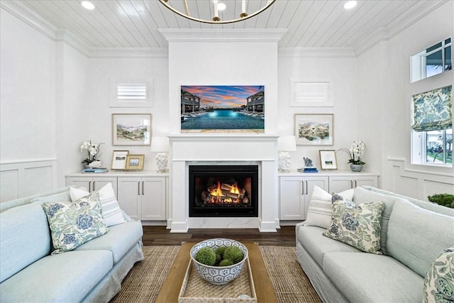251 Laughter Ln, Port Aransas, TX 78373 - living room featuring ornamental molding, dark wood-type flooring, a decorative wall, a warm lit fireplace, and recessed lighting