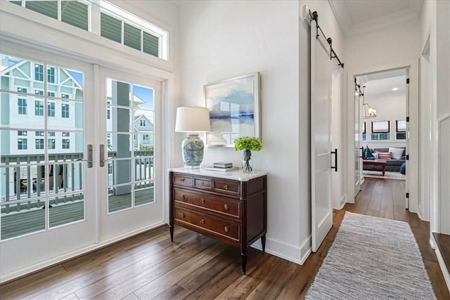 251 Laughter Ln, Port Aransas, TX 78373 - entryway with dark wood-style flooring, french doors, a barn door, and crown molding