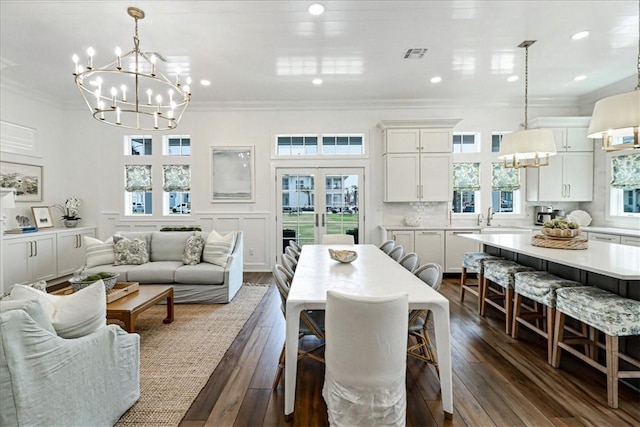 251 Laughter Ln, Port Aransas, TX 78373 - dining area featuring a chandelier, crown molding, dark wood-type flooring, recessed lighting, and french doors