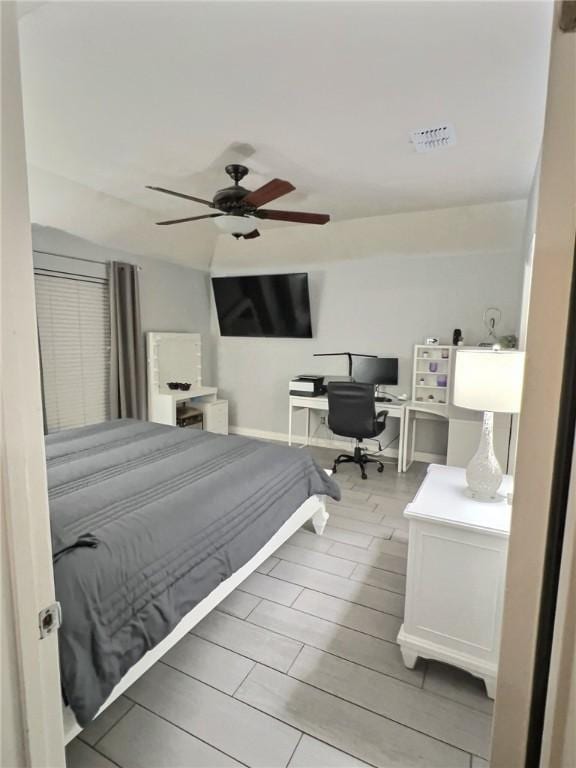 bedroom featuring a ceiling fan, wood finish floors, and visible vents