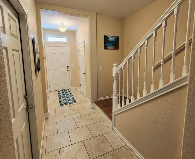 14878 Granada Dr Unit 502, Corpus Christi, TX 78418 - foyer entrance with baseboards, stairs, and light tile patterned floors