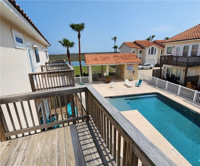 14878 Granada Dr Unit 502, Corpus Christi, TX 78418 - view of swimming pool featuring a fenced in pool, a patio area, a water view, and fence