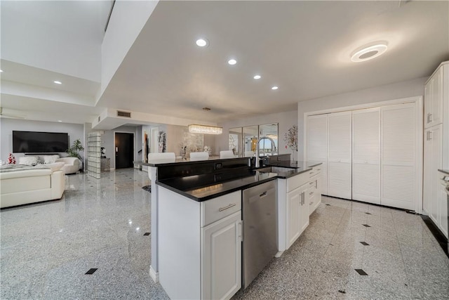 1400 Ocean Dr Unit 1104A, Corpus Christi, TX 78404 - kitchen with stainless steel dishwasher, recessed lighting, dark countertops, white cabinets, and an island with sink