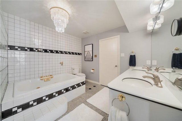 1400 Ocean Dr Unit 1104A, Corpus Christi, TX 78404 - bathroom with a relaxing tiled tub, double vanity, and a chandelier