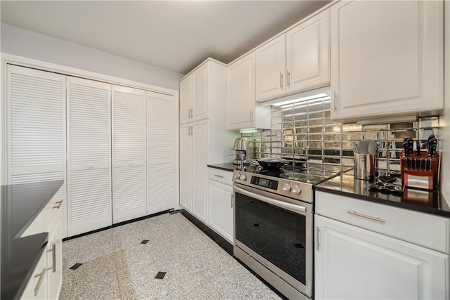 1400 Ocean Dr Unit 1104A, Corpus Christi, TX 78404 - kitchen featuring electric stove, dark countertops, tasteful backsplash, granite floors, and white cabinets