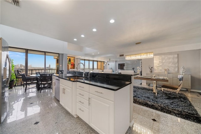 1400 Ocean Dr Unit 1104A, Corpus Christi, TX 78404 - kitchen featuring granite floors, recessed lighting, open floor plan, dark countertops, and white cabinets