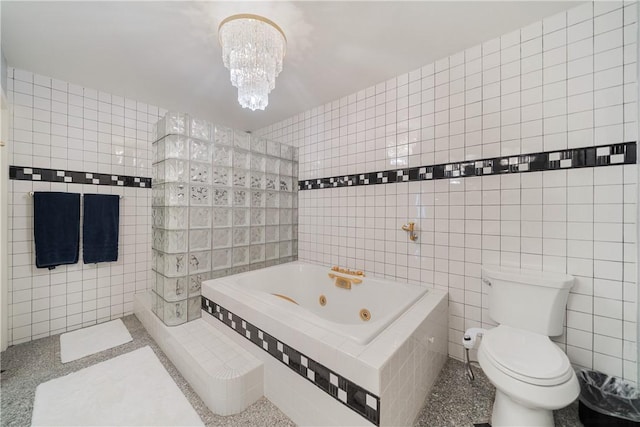 1400 Ocean Dr Unit 1104A, Corpus Christi, TX 78404 - bathroom with tile walls, a tub with jets, and a chandelier