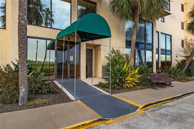 1400 Ocean Dr Unit 1104A, Corpus Christi, TX 78404 - view of exterior entry with stucco siding and a gate