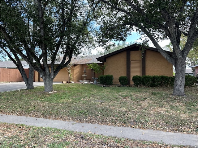 view of side of property with a garage and a lawn