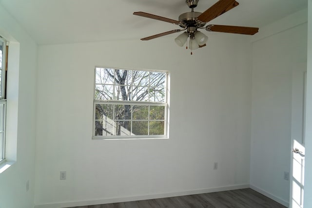 empty room with dark hardwood / wood-style flooring and lofted ceiling