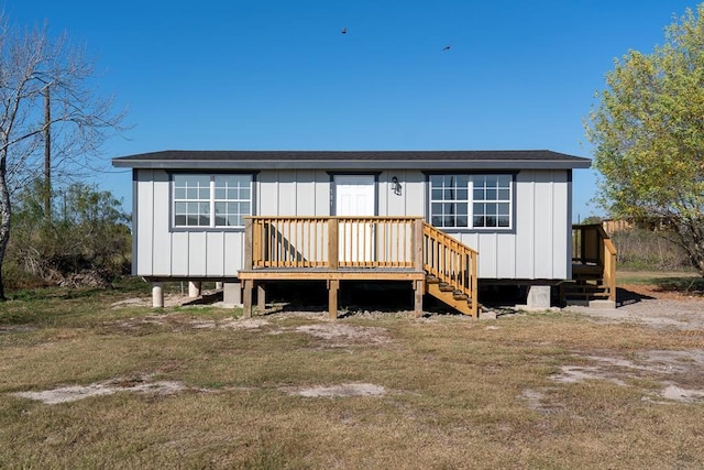 rear view of house with a yard and a deck