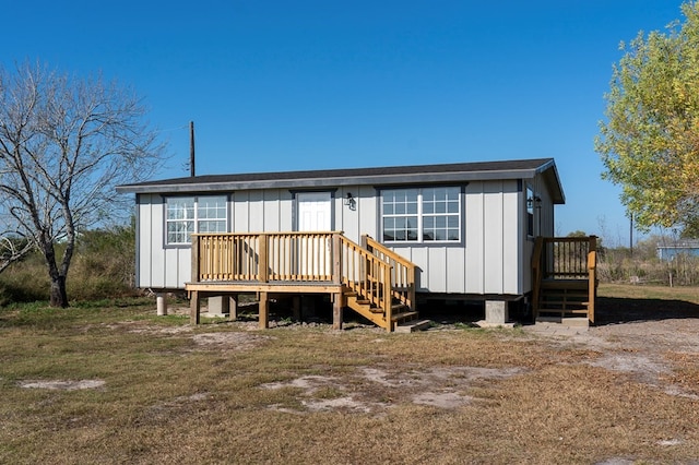 back of house featuring a wooden deck