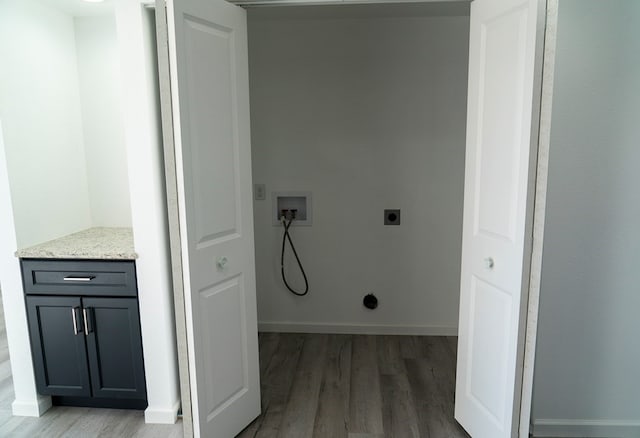 clothes washing area with washer hookup, hardwood / wood-style floors, and electric dryer hookup