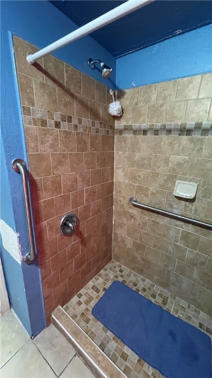 bathroom featuring tile patterned floors and a tile shower