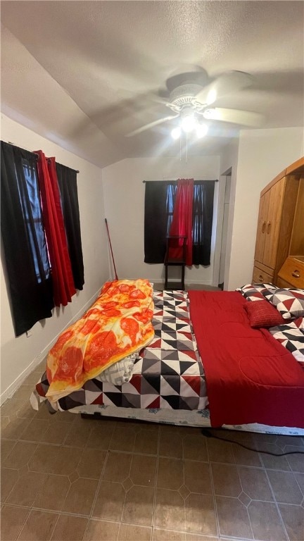 bedroom with ceiling fan and dark tile patterned floors