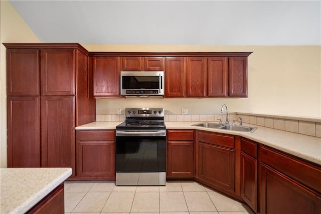 kitchen with dark brown cabinets, a sink, and stainless steel appliances