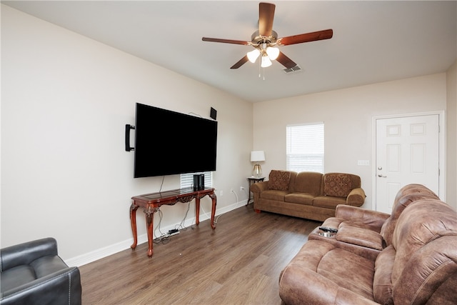 living room featuring ceiling fan and hardwood / wood-style flooring