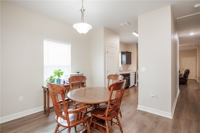 dining room featuring sink and dark hardwood / wood-style floors