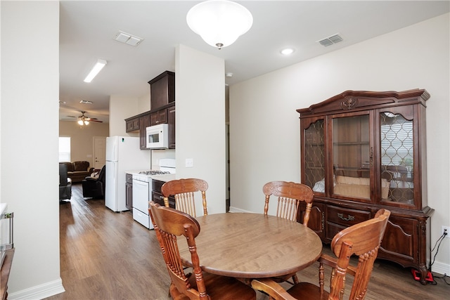 dining area featuring ceiling fan and dark wood-type flooring