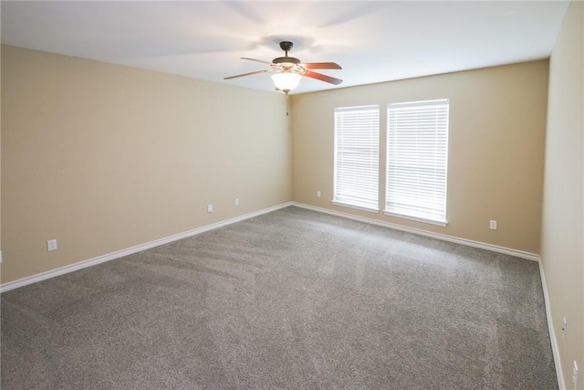 spare room featuring ceiling fan, carpet floors, and baseboards