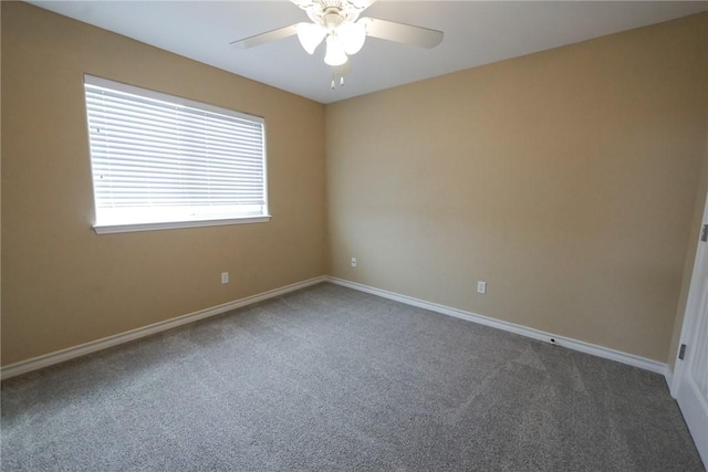 carpeted empty room with ceiling fan and baseboards