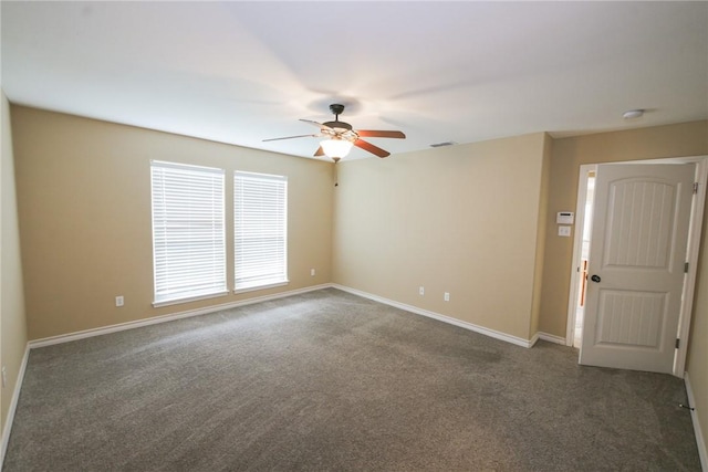 spare room featuring carpet floors, baseboards, visible vents, and a ceiling fan