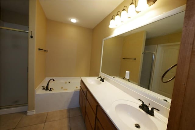 bathroom featuring a stall shower, tile patterned flooring, a sink, and a tub with jets