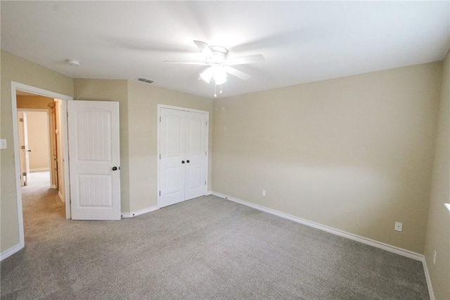 unfurnished bedroom featuring a closet, carpet flooring, visible vents, and baseboards