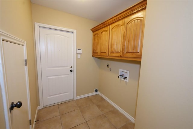 laundry area featuring washer hookup, light tile patterned floors, cabinet space, hookup for an electric dryer, and baseboards