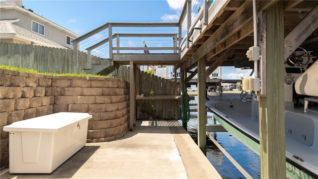 15269 Caravel Dr, Corpus Christi, TX 78418 - view of patio with fence, a water view, and stairway