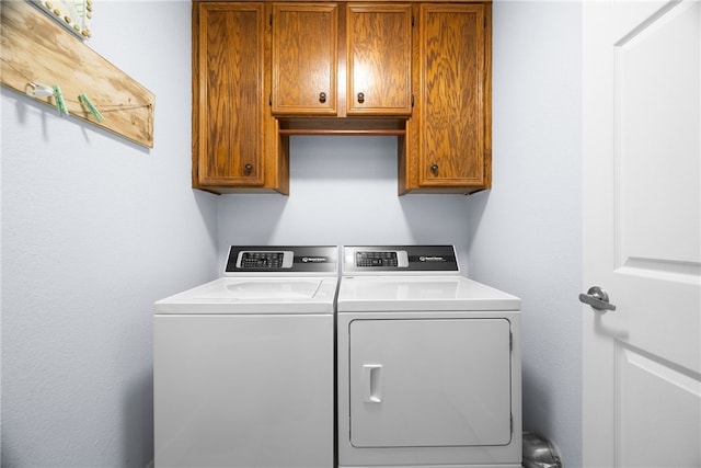 laundry room featuring cabinets and separate washer and dryer