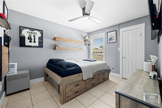 bedroom with ceiling fan, light tile patterned floors, and a closet