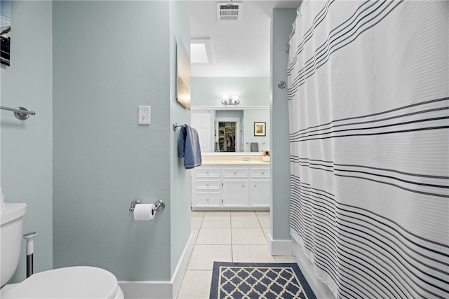 bathroom featuring vanity, a shower with shower curtain, tile patterned floors, and toilet