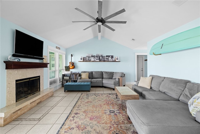 living room featuring a fireplace, light tile patterned floors, ceiling fan, and vaulted ceiling