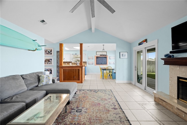15269 Caravel Dr, Corpus Christi, TX 78418 - living room featuring a tiled fireplace, a ceiling fan, light tile patterned flooring, and baseboards