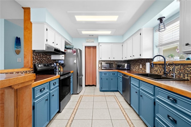 kitchen with blue cabinets, white cabinetry, and stainless steel appliances