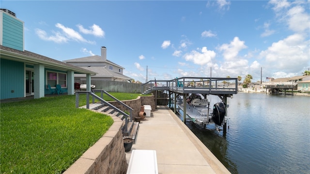 view of dock with a water view and a lawn