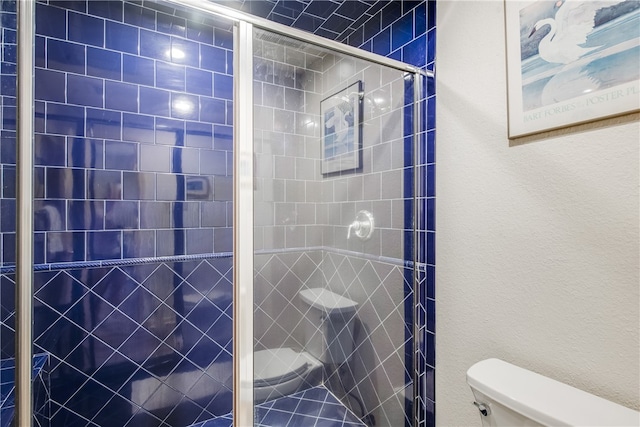 bathroom with tiled shower and toilet