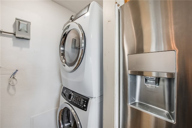 laundry room with stacked washer / dryer