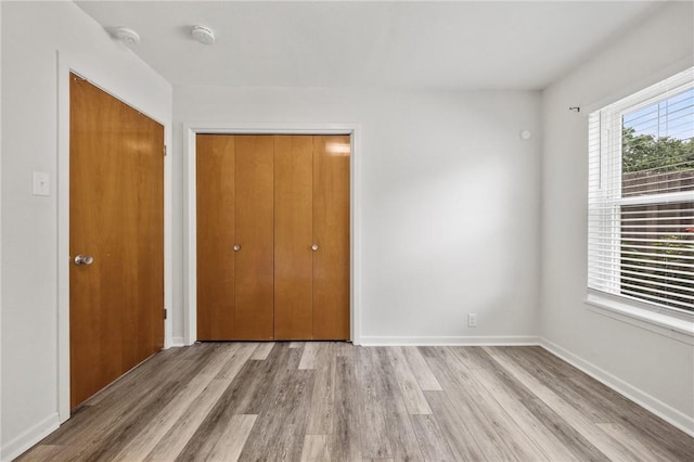 4414 Driftwood Pl, Corpus Christi, TX 78411 - unfurnished bedroom with wood finished floors, a closet, and baseboards