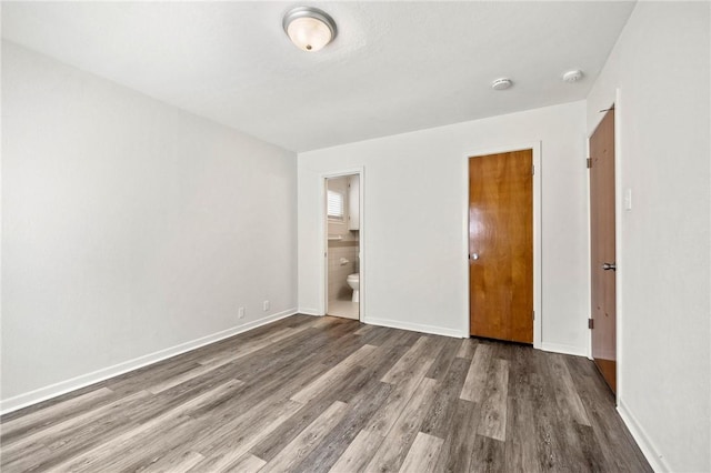 4414 Driftwood Pl, Corpus Christi, TX 78411 - unfurnished bedroom featuring wood finished floors, baseboards, and ensuite bathroom